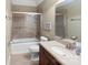 Well-lit bathroom featuring a bathtub with shower, modern vanity, and neutral tile flooring at 147 Pearl Bay Dr, New London, NC 28127