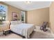 Comfortable bedroom with neutral walls, carpet, rocking chair, and lots of natural light at 147 Pearl Bay Dr, New London, NC 28127
