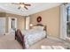 Cozy bedroom with ceiling fan, floral wreath, and lots of natural light at 147 Pearl Bay Dr, New London, NC 28127