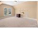 Spacious bonus room with a large window for natural light and a vintage cabinet for storage or display at 147 Pearl Bay Dr, New London, NC 28127