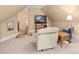 Well-lit bonus room featuring a comfortable recliner and a TV, offering a perfect spot for entertainment at 147 Pearl Bay Dr, New London, NC 28127