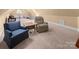 Cozy bonus room with carpeted floors, a comfy recliner, and space for relaxation or hobbies at 147 Pearl Bay Dr, New London, NC 28127