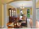 Formal dining room features elegant chandelier, wainscoting, and large windows at 147 Pearl Bay Dr, New London, NC 28127