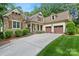 View of the home showcasing its stone accents, front porch, and a spacious driveway at 147 Pearl Bay Dr, New London, NC 28127