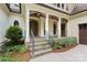 Charming front porch with stone steps, decorative columns, and a well-maintained garden at 147 Pearl Bay Dr, New London, NC 28127