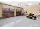 Spacious garage with two wooden doors, high ceilings, and ample room for parking and equipment at 147 Pearl Bay Dr, New London, NC 28127