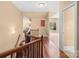 Second story hallway with wood floors and iron railing at 147 Pearl Bay Dr, New London, NC 28127