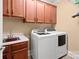 Functional laundry room with modern washer and dryer, and built in cabinets at 147 Pearl Bay Dr, New London, NC 28127