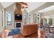 Cozy living room featuring a stone fireplace, large windows, hardwood floors, and water views at 147 Pearl Bay Dr, New London, NC 28127
