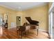 Living room with a grand piano, hardwood floors, and natural light at 147 Pearl Bay Dr, New London, NC 28127