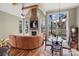 Cozy living room with stone fireplace, wood floors, and beautiful lake views at 147 Pearl Bay Dr, New London, NC 28127
