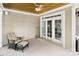 Cozy porch featuring a comfortable chair, ceiling fan, and white-framed glass doors leading inside at 147 Pearl Bay Dr, New London, NC 28127