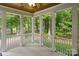 Inviting screened porch with views of a lush, green backyard and a glimpse of the tranquil lake beyond at 147 Pearl Bay Dr, New London, NC 28127