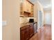 Wet bar area with cabinetry, granite countertop, sink, tile backsplash, and refrigerator at 147 Pearl Bay Dr, New London, NC 28127