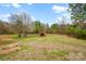 Spacious backyard with grass and a red shed visible in the distance at 155 Country Ln, Mooresville, NC 28115