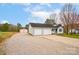 This home features a two-car garage, a long gravel driveway, and a storage building at 155 Country Ln, Mooresville, NC 28115