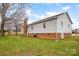 Rear exterior showcasing the home's siding, brick foundation, and expansive yard at 155 Country Ln, Mooresville, NC 28115