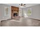 The cozy living room has a brick fireplace, large windows, and modern flooring at 155 Country Ln, Mooresville, NC 28115