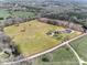 Aerial view of sprawling estate featuring a home, barn, pasture, and pond at 1790 Faires Rd, Rock Hill, SC 29730