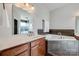 Bathroom featuring a soaking tub with tile surround and a vanity with a sink and wood cabinets at 1790 Faires Rd, Rock Hill, SC 29730