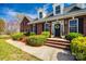 Charming brick home entrance with manicured bushes, black shutters, and a welcoming wreath on the door at 1790 Faires Rd, Rock Hill, SC 29730