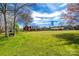 Expansive front yard with mature trees leading to a red brick home with black shutters at 1790 Faires Rd, Rock Hill, SC 29730