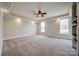 Spacious main bedroom with tray ceiling, ceiling fan, two windows, and neutral-colored carpet at 1790 Faires Rd, Rock Hill, SC 29730