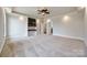 Spacious main bedroom with tray ceiling, built-in shelves, neutral-colored carpet, and two windows at 1790 Faires Rd, Rock Hill, SC 29730