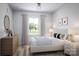 Serene bedroom with neutral tones, wood furniture, and a large window offering natural light at 2117 Moss Bluff Dr, Mint Hill, NC 28227