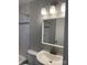 Bright bathroom features decorative tiled shower, updated vanity, and modern lighting at 213 Crowell Ave, Albemarle, NC 28001