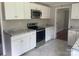 A well-lit kitchen with modern white cabinets, stainless steel appliances, and granite countertops at 213 Crowell Ave, Albemarle, NC 28001