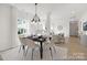 Chic dining room with natural light, modern chandelier, and open floor plan connecting to the living area at 2310 Bulwarks Ct # 9P, Albemarle, NC 28001