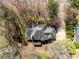 Aerial view of a home with a dark gray roof surrounded by trees and a driveway at 2430 Berkshire Dr, Salisbury, NC 28146