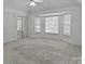 Bright bedroom featuring large windows, neutral carpet, and ample closet space at 2430 Berkshire Dr, Salisbury, NC 28146