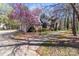 Beautiful side view of brick home with a driveway, blossoming tree, and green shrubbery at 2430 Berkshire Dr, Salisbury, NC 28146