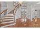 Grand foyer featuring hardwood floors, elegant staircase, and stunning chandelier at 2430 Berkshire Dr, Salisbury, NC 28146