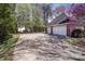 Attached two car garage and extra one car garage featuring white doors and a large driveway at 2430 Berkshire Dr, Salisbury, NC 28146