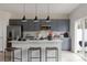 Modern kitchen with gray cabinetry, stainless steel appliances, a white island, and barstool seating at 3012 Hutton Gardens Ln, Charlotte, NC 28269