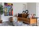 Inviting living room featuring a leather sectional, a modern coffee table, and contemporary artwork at 3012 Hutton Gardens Ln, Charlotte, NC 28269