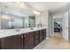 Bathroom with double sinks, a large mirror, and a view of the bedroom and shower at 3034 Oakmere Rd, Waxhaw, NC 28173