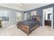 This bedroom features a wooden bed frame, neutral carpet, light gray walls and a bathroom entrance at 3034 Oakmere Rd, Waxhaw, NC 28173
