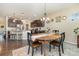 Light-filled dining area with dark wood floors and modern decor adjacent to the kitchen at 3034 Oakmere Rd, Waxhaw, NC 28173