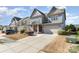 Charming two-story home with gray siding, an attached garage, and a well manicured front yard at 3034 Oakmere Rd, Waxhaw, NC 28173