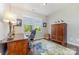 Bright home office with a large desk, natural light, and neutral wall color at 3034 Oakmere Rd, Waxhaw, NC 28173