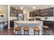 Spacious kitchen island featuring granite countertops, seating, and modern stainless appliances at 3034 Oakmere Rd, Waxhaw, NC 28173