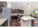 Well-equipped kitchen with stainless appliances, granite counters, and adjacent dining area at 3034 Oakmere Rd, Waxhaw, NC 28173