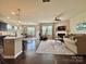 Open-concept living room and kitchen with neutral tones, natural light, and modern features at 3034 Oakmere Rd, Waxhaw, NC 28173