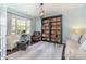 Inviting living room with custom bookshelf, stylish seating, and a bright window that enhances the room's charm at 3034 Oakmere Rd, Waxhaw, NC 28173