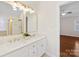 Bright, well-lit bathroom showcasing double sinks and a glimpse of a shower with gold accents at 3222 Shadow Lake Ln, Matthews, NC 28104