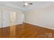 Spacious bedroom with beautiful hardwood floors, tray ceiling and neutral color palette at 3222 Shadow Lake Ln, Matthews, NC 28104